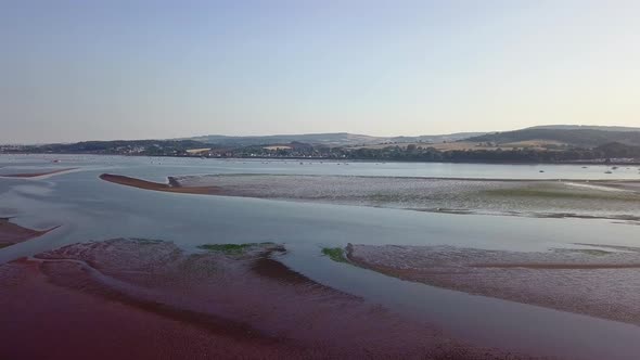 Flying over tourist beach town of Lympstone England. This is an all season location where tourism bl