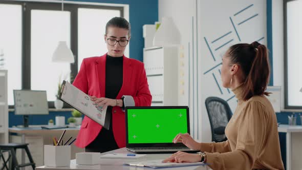 Team of Coworkers Using Green Screen on Laptop to Work