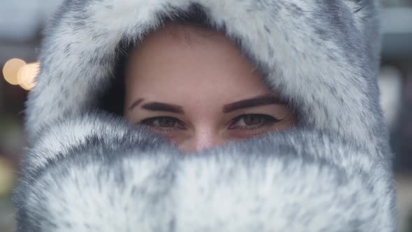 Extreme Close-up Eyes of Beautiful Caucasian Girl. Pretty Young Woman with Brown Eyes Hiding Face in