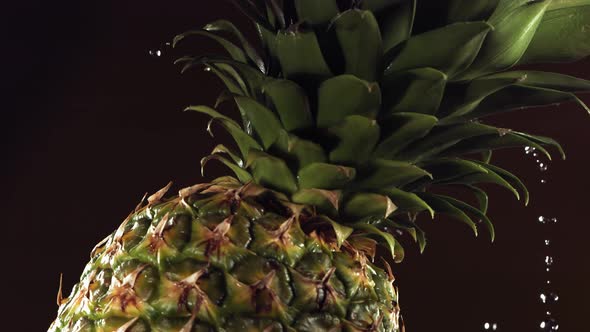 Super Slow Motion Water Drips on Rotating Pineapple