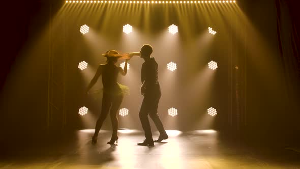 Concept of Social Dance and Relationships. Silhouette of Young Beautiful Couple Dancing Sensual