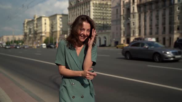 Smiling Crazy Adult Woman Strolls Along a Busy Highway