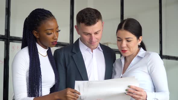 Multiracial Coworkers Group Talk Work Together Share Ideas on Digital Marketing Strategy at Office