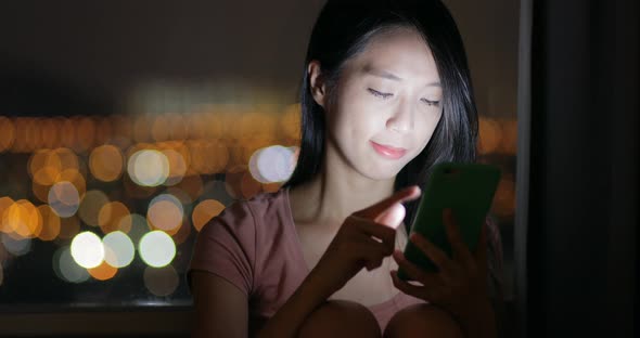 Woman use of cellphone at night 