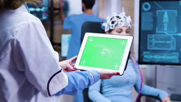 Female Doctor Holding Tablet with Green Screen in a Modern Neurology Lab Science