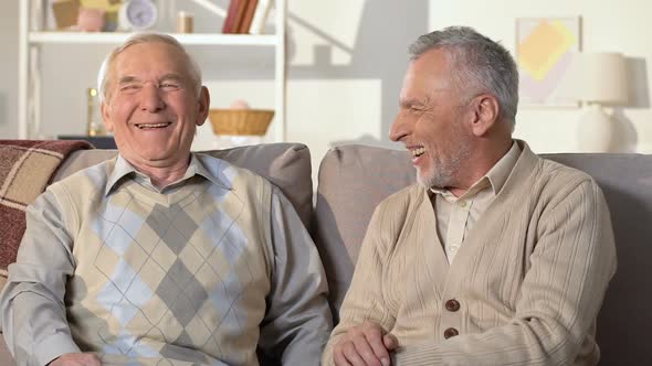 Elderly Best Friends Talking and Laughing Sitting on Sofa, Pension Leisure, Fun