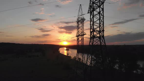 Aerial View Silhouette of Electric Tower Over Sunset Time. Electricity Pylon Against Sky.