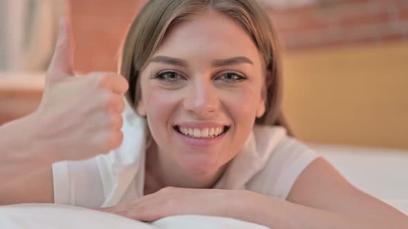 Close Up of Successful Young Woman Doing Thumbs Up