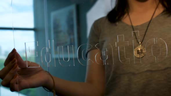 Woman Holding Glass Education Sign