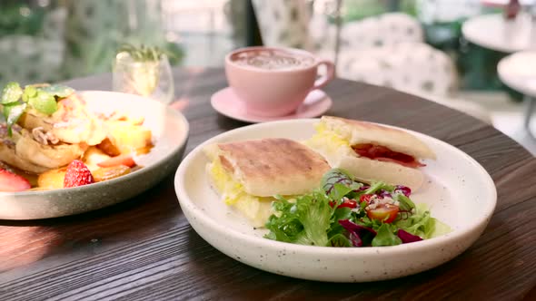 Cup of Coffee Sandwich with Egg Cheese Bacon and Salad and Banana Toast