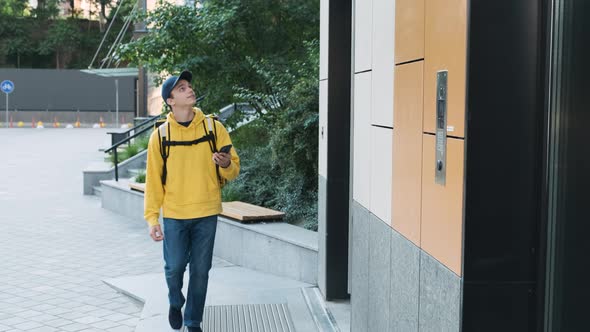 Delivery Man with Big Thermal Backpack Ringing a Door