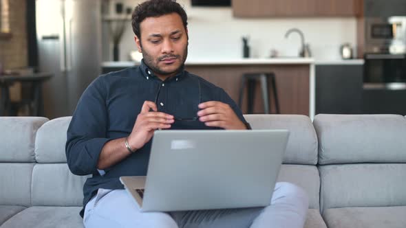 Multiethnic Hindu Freelancer Guy Using Laptop Computer at Home