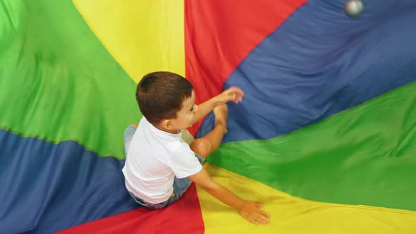 Happy Toddlers Having an Active Sensory Play with Texture and Colors at the Nursery School