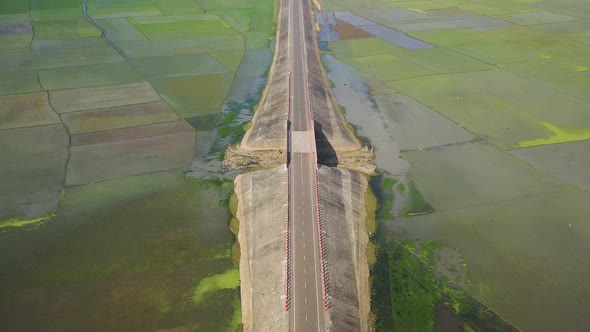 Aerial view of a road among the fields in Sapahar, Rajshahi, Bangladesh.