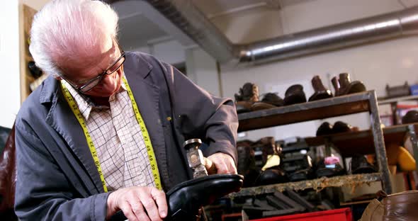 Shoemaker hammering on a shoe