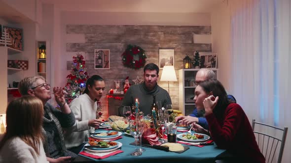 Different Generation Around the Table Celebrating Christmas