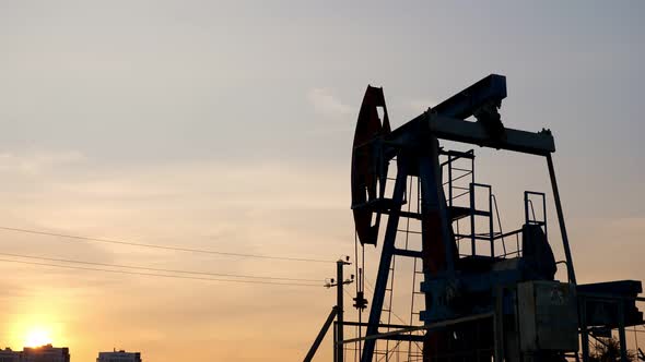 Oil Rocking Chairs on the Background of the Sunset Sky