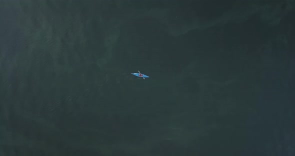 Blue Kayak Floats on the River Aerial View From Above