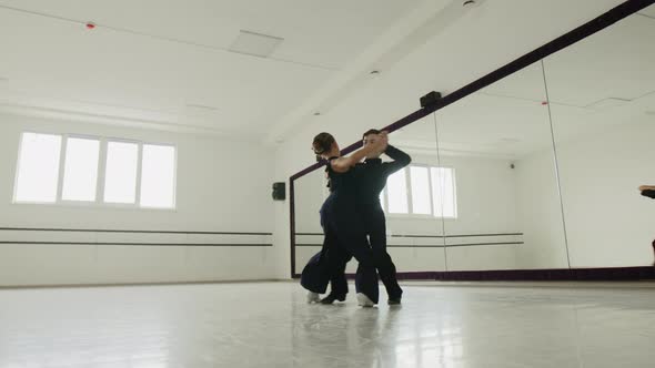 Choreography Lesson with a Boy and Girl in a Dancing Hall