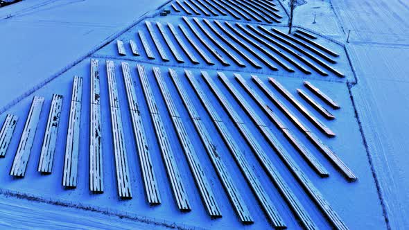 Frozen photovoltaic farm in winter. Alternative energy. Snowy solar panels.