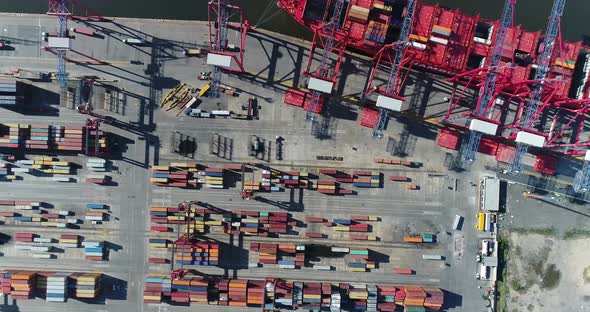 erial scene with drones. Container terminal of the port. Camera down with a view of ship and contain