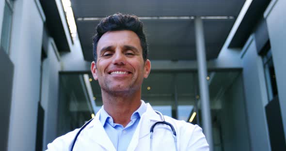 Smiling doctor standing in hospital