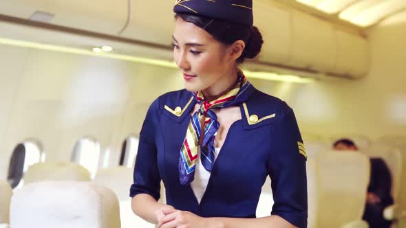 Cabin Crew or Air Hostess Working in Airplane