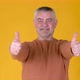 Cheerful Senior gray-haired man in white shirt showing thumb up - VideoHive Item for Sale