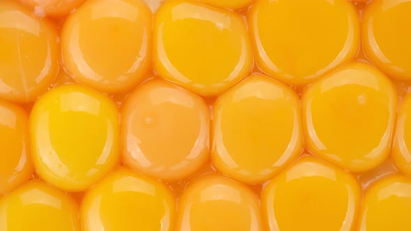 eggs yolks top view, rotation. yolks for making dough. Yolk for cooking. 4K UHD video