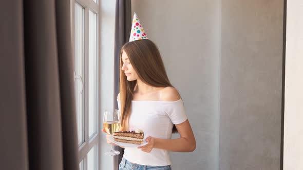 Birthday Girl Blowing Candle on Cake and Drinking Wine