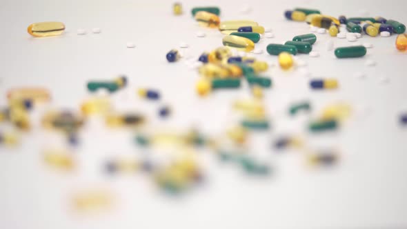 Macro Rack Focus of Pill Varieties Strewn on White Background