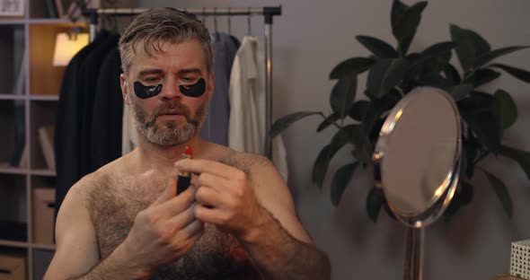 Brutal Mature Bachelor Opening and Closing Red Lipstick While Shaking Head, Bearded Guy in 40s