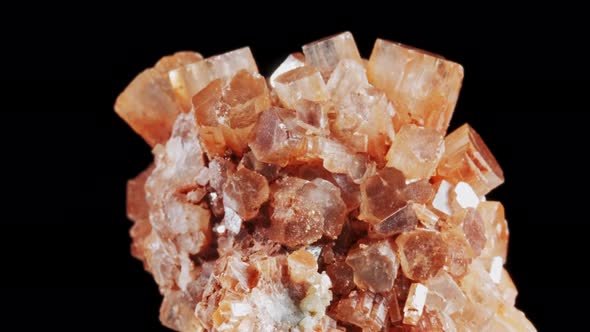 Seamlessly Rotating a Blood Orange Mineral Aragonite in Front of Black Background