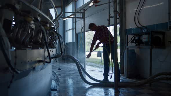 Farmer Washing Milking System in Technological Farm Using Hose