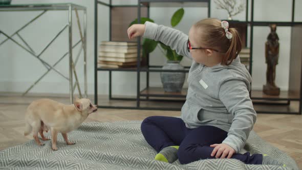 Lovely Child with Down Syndrome Bonding with Pet