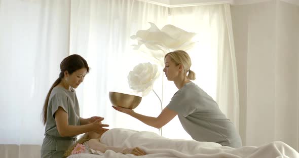 Professional Women Make Atmosphere Using Tibetan Bowl