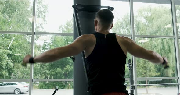 Strong Muscular Male Working on Skis Simulator. Cross Fitness Training in the Gym