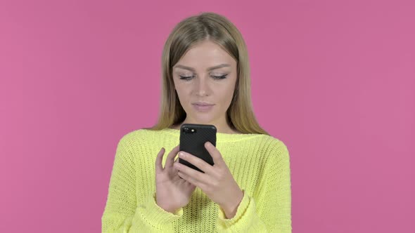 Happy Young Girl Using Smartphone, Pink Background