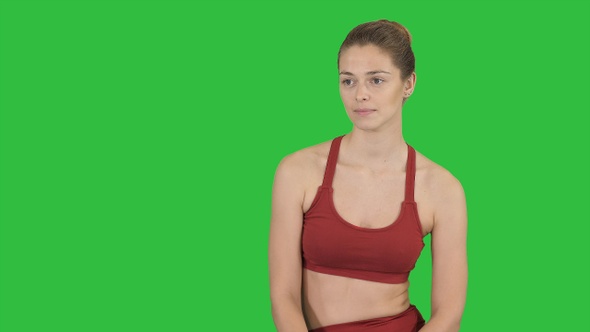 Beautiful girl in sportswear listening to someone talking