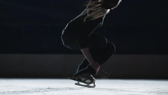 Slow Motion Cinematic Shot of Young Female Artistic Figure Skater is Performing a Woman's Single