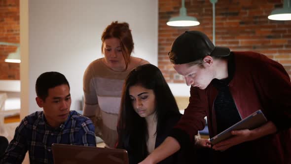 Executives discussing over laptop in creative office 4k