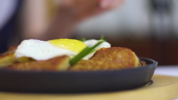 A Lady in Evening Dress with Knife Cuts the Yolk of Fried Egg and It Flows Out