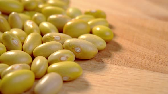 Dried organic yellow mayocoba beans on a rustic board. Macro