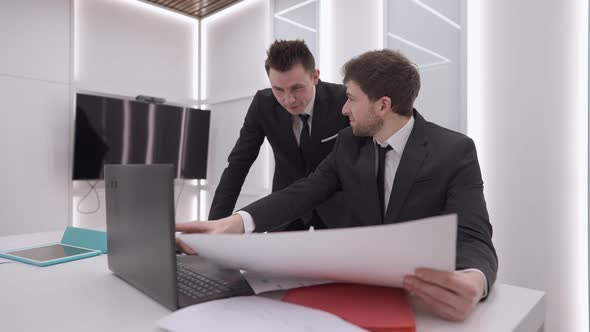 Two Positive Smiling Male Colleagues Giving Highfive in Slow Motion Analyzing Ecommerce Strategy in