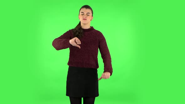 Unhappy Girl Showing Thumbs Down Gesture. Green Screen