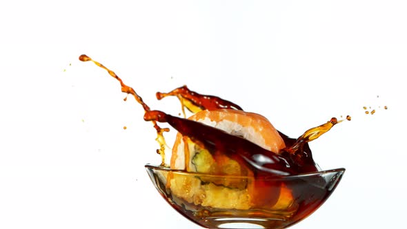 Super Slow Motion Shot of Fresh Sushi Falling Into Soy Sauce Isolated on White at 1000Fps