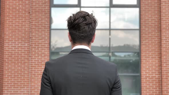 Back View of Walking Businessman