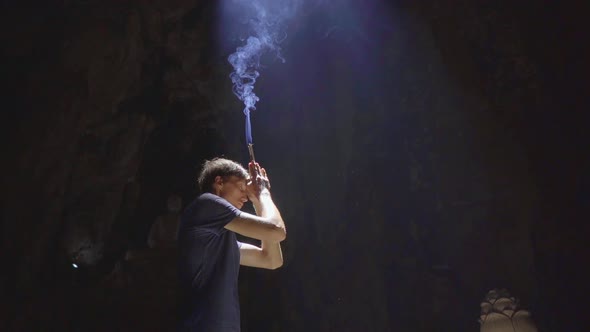 Slowmotion Shot of a Young European Man Which Is Praying Holding Smoking Aroma Sticks in His Hands