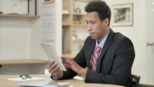 African Businessman Browsing on Tablet