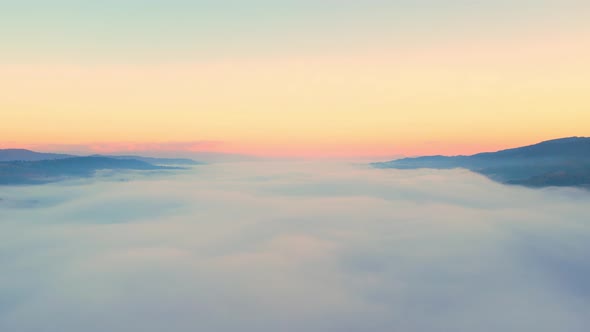 4K Aerial video Beautiful sunrise above dense clouds and fog in the morning